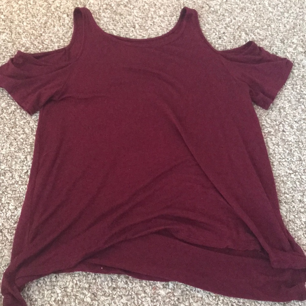 Burgundy shirt with cut out shoulders.